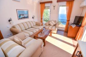 a living room with two couches and a television at Apartments Villa Sveti Nikola in Budva