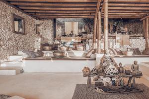a room filled with lots of different types of ceramics at The Baha House in Uluwatu