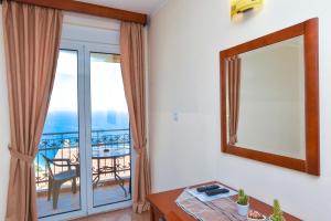 a room with a mirror and a table and a balcony at Apartments Villa Sveti Nikola in Budva