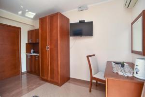 a room with a cabinet and a table and a chair at Apartments Villa Sveti Nikola in Budva