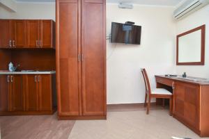a room with a desk and a tv on a wall at Apartments Villa Sveti Nikola in Budva