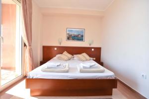 a bedroom with a bed with two pillows on it at Apartments Villa Sveti Nikola in Budva