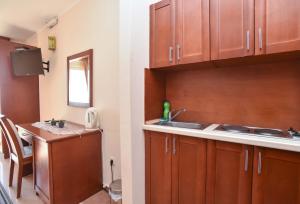 a kitchen with wooden cabinets and a sink at Apartments Villa Sveti Nikola in Budva