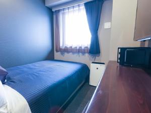 Letto o letti in una camera di HOTEL LiVEMAX Yokohama-Eki Nishiguchi