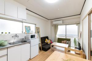 a kitchen and living room with a sink and a table at LUANAHOTEL IN WASEDA in Tokyo