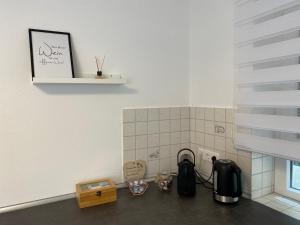 eine Küche mit einer Theke mit einer Kaffeemaschine und einem Fenster in der Unterkunft Ferienwohnung Vörstetten in Vörstetten