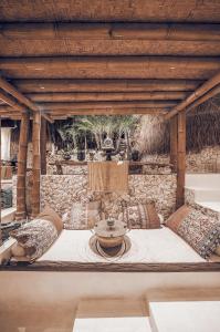 a stone walled room with a fountain in the middle at The Baha House in Uluwatu