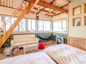 a bedroom with a bed and a hammock in a room at Country Cottage Wakiaiai in Nakafurano +64 photos