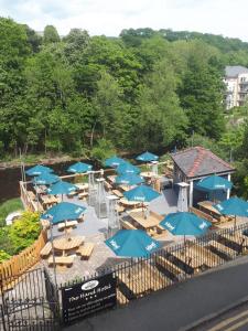 a group of blue umbrellas and chairs on a patio at The Hand Hotel in Llangollen