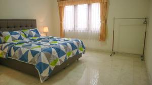 une chambre avec un lit et une fenêtre dans l'établissement Dago Asri House (3 Bedrooms, 6 Pax, 500m2), à Bandung