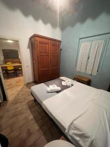 a bedroom with a large bed with towels on it at Agriturismo Baratti in Baratti