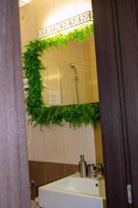 een badkamerspiegel met een wastafel voor de badkamer bij Le Premier in Constanţa