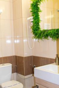 a bathroom with a toilet and a sink and a mirror at Le Premier in Constanţa