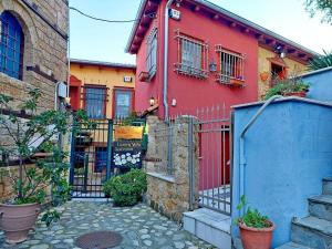a red house with a gate in front of it at The House by the River Luxury Villa in Veria