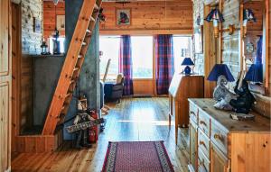 a living room with a staircase in a log cabin at Lovely Home In Kvinlog With House A Mountain View in Kvinlog