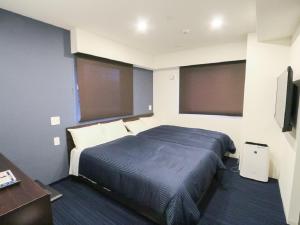 Ένα ή περισσότερα κρεβάτια σε δωμάτιο στο HOTEL LiVEMAX Akihabara Kita