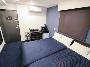 Ένα ή περισσότερα κρεβάτια σε δωμάτιο στο HOTEL LiVEMAX Akihabara Kita