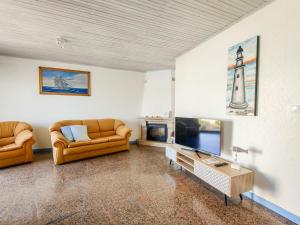 a living room with two couches and a tv at Viana Fishers House - Pool & Beach ! in Viana do Castelo