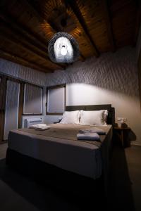 a bedroom with a large bed with a light at Eumorphia Studios & Apartments in Skiathos Town