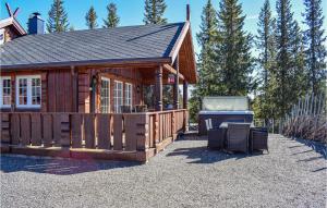 a small cabin with a grill in a yard at Nice Home In Mesnali With Jacuzzi, Sauna And Wifi in Mesnali