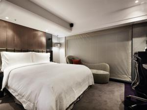 Rúm í herbergi á The Tango Hotel Taipei FuHsing