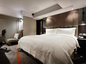 Rúm í herbergi á The Tango Hotel Taipei FuHsing