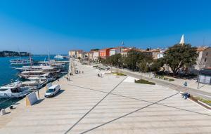 a city street with boats parked on the water at Hotel Dua Residence in Poreč