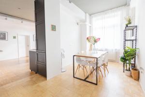 a dining room with a table and chairs at Green Residence Boutique Lofts & Villa in Offenbach