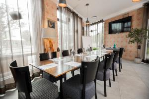 a dining room table and chairs in a room at Wellton Riga Hotel & SPA in Rīga