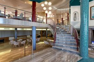 a staircase in a building with tables and chairs at Perla Marina in Nerja