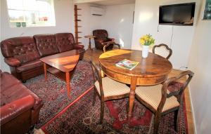 ein Wohnzimmer mit einem Tisch und einem Sofa in der Unterkunft Beautiful Home In Grimslv With Sauna in Grimslöv