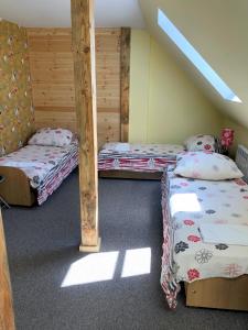 two bunk beds in a room with a attic at Dworek Rogowo in Choroszcz