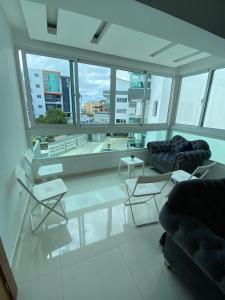 a living room with a lot of windows at Fully equipped apartment with sea view in La Viva