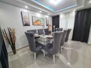 a dining room with a glass table and chairs at Fully equipped apartment with sea view in La Viva