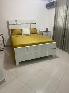 a bedroom with a bed with a yellow blanket on it at Fully equipped apartment with sea view in La Viva