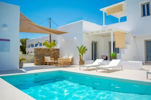 a pool in the backyard of a villa at White Blossom in Parikia