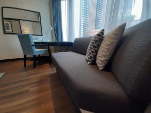a living room with a couch and a desk at Meliá Kuala Lumpur in Kuala Lumpur