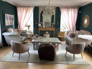 a living room with a couch and a table and chairs at Domaine "Les Bois Flottes" dans Maison de Charme au bord de mer et proche de Cabourg in Merville-Franceville-Plage