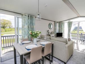 a living room with a table and a couch at Hares Meadow in Caersws