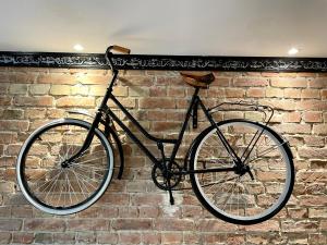 a bike is hanging on a brick wall at Petite Viste No. 3 Apartment in Toruń