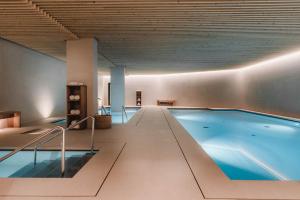 a large swimming pool in a large room at Hotel Arima & Spa - Small Luxury Hotels in San Sebastián