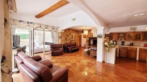 un soggiorno con divano e sedie e una cucina di Villa Provençale â Sainte Maxime, Golf de Saint Tropez a Sainte-Maxime