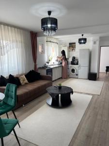 a woman standing in the kitchen of a living room at Adriana home in Turda +11 photos