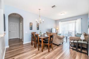 a dining room and living room with a table and chairs at Gorgeous Top-Floor Condo w Private Balcony in Orlando