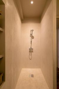 - une douche dans une chambre avec un mur dans l'établissement Le Saint Michel, à Dijon