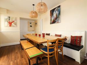 a dining room with a table and chairs and a couch at 99 Tower Road in Newquay