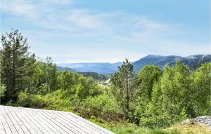 a view of the mountains from a roof of a house at Awesome Home In Kvinlog With 3 Bedrooms And Wifi in Kvinlog
