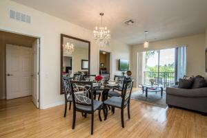 a dining room and living room with a table and chairs at Luxurious Condo w Modern Design, near Disney in Orlando