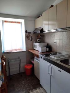 a small kitchen with white cabinets and a window at Apartment in Pula/Istrien 10835 in Vintijan