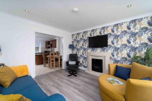 a living room with a couch and a fireplace at The Barn in St Ives